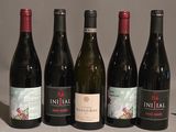 several bottles of wine are lined up on a table