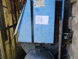 a blue tank with a sign on it next to a wall
