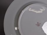 a white plate with a piece of paper on it