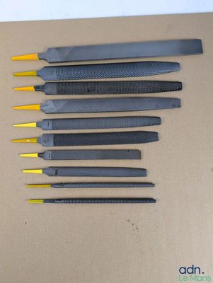 cinq types d'outils différents posés sur une boîte en carton