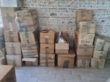 many boxes stacked on top of each other in a room