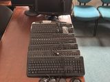 a lot of computer equipment on the desk in the office