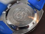 a close up of a watch with a blue strap