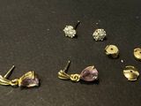 a close up of a bunch of earrings on a table