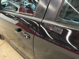 a car door handle with a sticker on the side of it