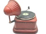 a red record player with a red lamp on top of it