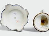 a small cup and saucer sitting next to each other