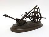statue of a wheel and a wheelbarrower on a white background