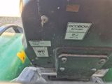 a close up of a green tractor with a sticker on the back of it