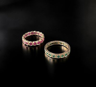 a pair of emerald and pink sapphire rings