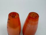 two orange vases sitting next to each other on a white surface
