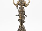 a bronze statue of a woman holding a bird on a pedestal