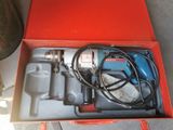 a red box with a drill and other tools in it