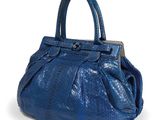 a close up of a blue purse on a white background