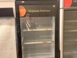 two refrigerators that are sitting side by side in a store