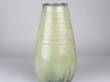 a green vase that is sitting on a table