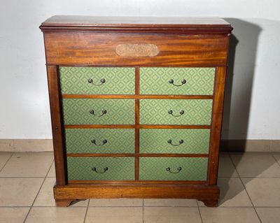 a wooden chest of drawers with many drawers on it