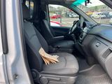 the interior of a car with a paper bag in the passenger seat