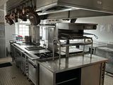 a large kitchen with a lot of stainless steel counter tops