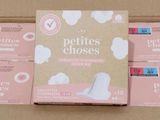 the box is full of pink and white sanitary pads in it