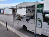 a food truck that is parked on the side of the road