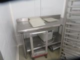 a metal table with a pan on it in a kitchen