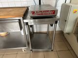 a stainless steel table with a sign on it in a kitchen