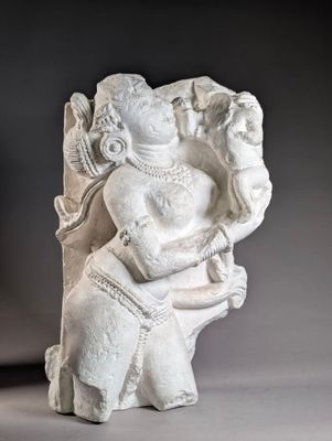 statue of a seated man holding a bird in his right hand