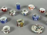 a lot of small cups and saucers on the table