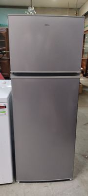 two refrigerators sitting next to each other in a warehouse