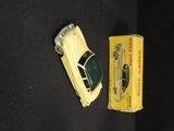 a yellow toy car next to a box of matches