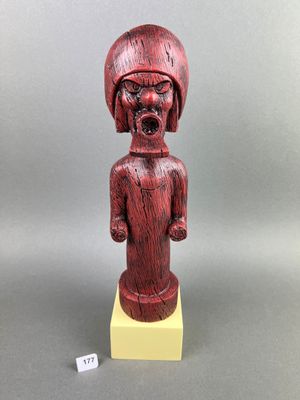 a wooden statue of a man with a hat on his head