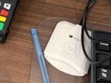 a keyboard and a pen sitting on a desk next to a cell phone