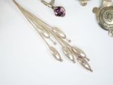 a silver necklace and a pair of earrings on a table