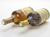 two bottles of wine sitting next to each other on a table