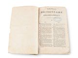 an old book open on a white surface