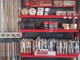 a red shelving with many items on it in a store