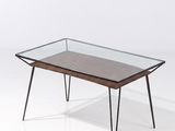 une photo d'une table basse avec un plateau en verre et des pieds en métal