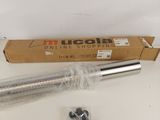 a close up of a metal pipe and a cardboard box on a table
