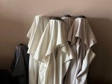 several robes are hanging on a rack in a room