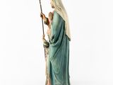 a statue of a woman holding a staff in her hand