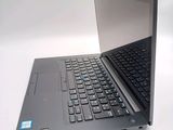 a laptop that is open on a white surface