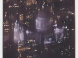 an aerial view of a city at night with buildings lit up