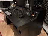an image of a recording studio with a desk and monitors