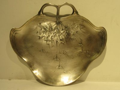 a silver plate with a flower design on it