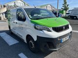 a green and white van parked in a parking lot