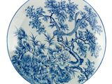 an image of a blue and white plate with a bird on it