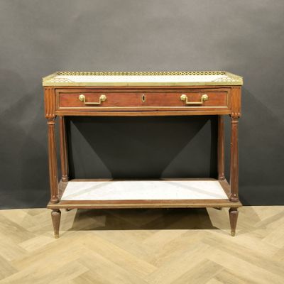 a wooden table with a marble top on a wooden floor