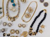several different types of jewelry are displayed on a white surface