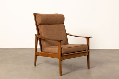 the chair is made of wood and has a brown upholstered seat